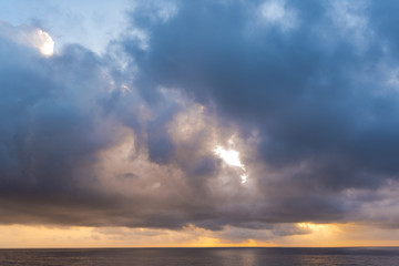 Naklejka na ściany i meble Dramatic cloudy Sky over Sea, morning sky and water, sunrise above ocean