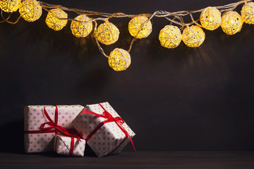 Glowing New Year garlands on a dark background. Copy space. Christmas, New Year background.