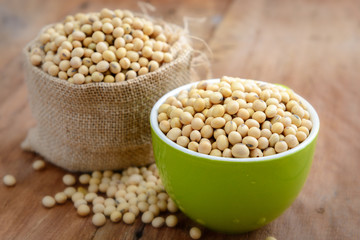 Soy beans in green bowl and sack