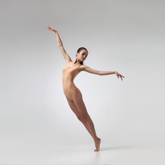 Fototapeta premium young beautiful dancer in beige swimsuit