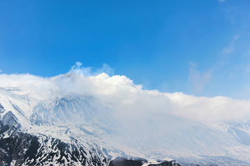 winter landscape of smoke around mount Etna crater