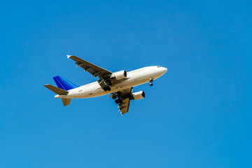 Passenger Airplane Flying On Clear Blue Sky