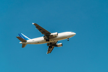 Fototapeta na wymiar Passenger Airplane Flying On Clear Blue Sky