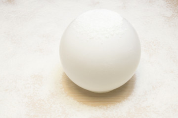 Glass white ball covered with snow