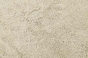 Beige woolen carpet texture background