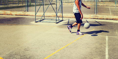 Basketball player in a playground in vintage tone