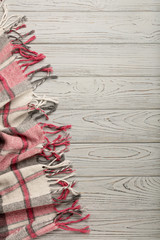 Plaid on a light wooden background.