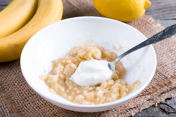 Banana puree with yogurt in a white bowl