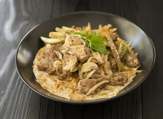 beef stroganoff in black plate