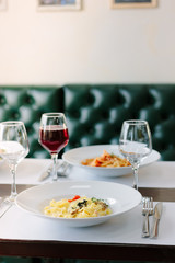 Traditional fettuccine pasta with mushrooms at italian restaurant.
