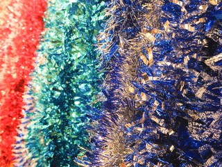 A lot of Christmas tinsel. Color festive Christmas background.
