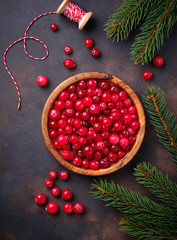Fresh ripe cranberry in wooden bowl