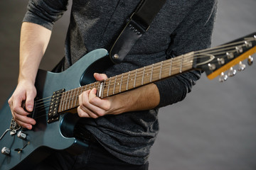 Male hands playing electric guitar
