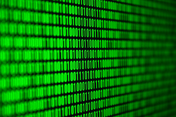 An image of a binary code made up of a set of green digits on a black background