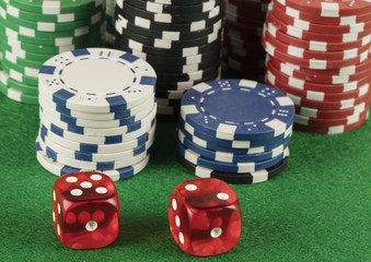 two red dices and different color chips