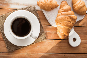 aroma cup of coffee with sweet croissant