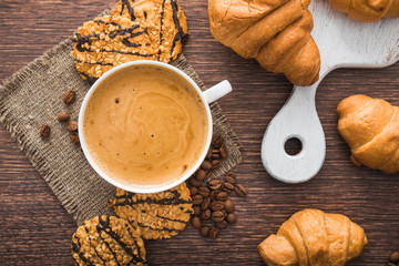 aroma cup of coffee with sweet croissant