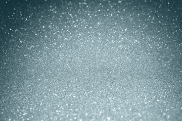 Silver glitter and sparkling blur bokeh light effect on snow white background. Glittering silver or shining particles texture with sparkling light for modern Christmas background design template
