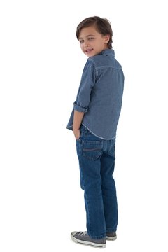Boy posing with hands in pocket against white background