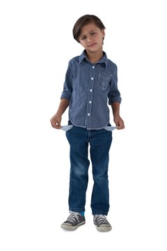 Boy standing with empty pockets against white background