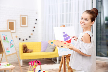 Fototapeta na wymiar Little girl painting boat at home
