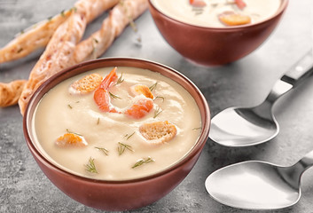 Bowl with yummy shrimp cream soup on table