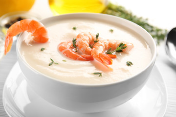 Bowl with yummy shrimp cream soup on table, closeup