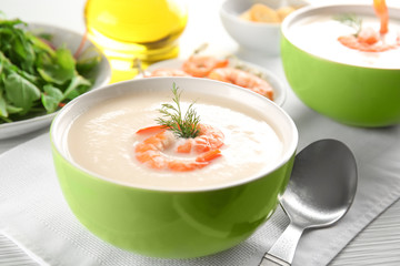 Bowl with yummy shrimp cream soup on table, closeup