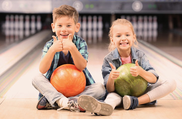 Obraz premium Cute little children at bowling club