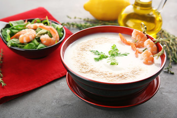 Bowl with yummy shrimp cream soup on table