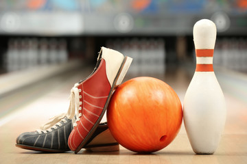 Shoes, pin and ball on floor in bowling club