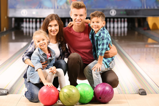 Family having fun in bowling club