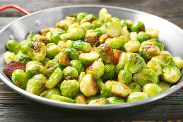 Frying pan with roasted brussel sprouts on table, closeup
