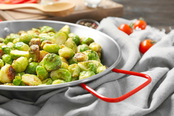 Frying pan with roasted brussel sprouts on table