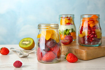 Glassware with delicious fruit salads on table