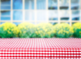 Product display table covered checkered red picnic cloth.