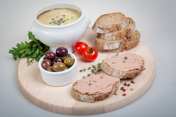 plate with slices of bread with home made pate, decorated with vegetables
