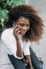 Beautiful hispanic woman talking on phone indoors.