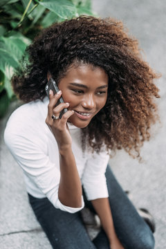 Beautiful Hispanic Woman Talking On Phone Indoors.