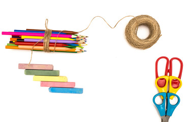 Pile of colored pencils tied with a jute rope and colorful chalk isolated on white background. Craftsman.