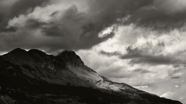 Timelapse of the Aiguilles de Chabrieres (Chabrieres Needles) with passing clouds in Black & White. Ecrins National Park, Hautes-Alpes, Southern French Alps. France