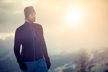 skier man detail wearing second layer jacket. exploring snowy land walking and skiing with alpine...