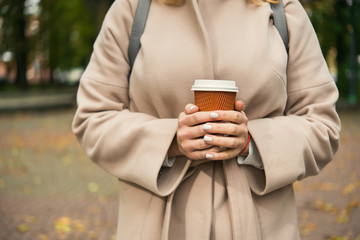 young woman with paper takeaway coffee cup