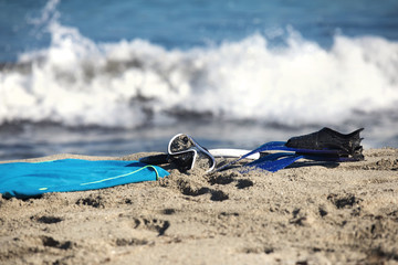 Fototapeta na wymiar Fins, a diving mask and a snorkel on the beach 