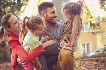 Mother and daughter hugging a Daddy.
