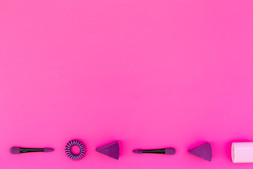 Bright decorative cosmetics. Llilac eyeshadow applicator on pink background top view copyspace