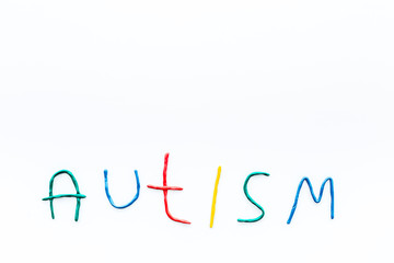 Childhood diseases. Word autism on white background top view copyspace