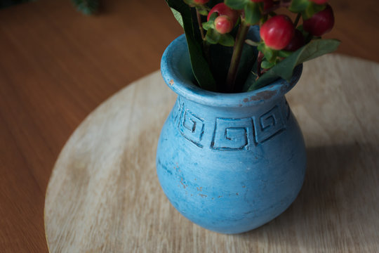 Rustic blue vase perfect for some red mistletoes centerpiece