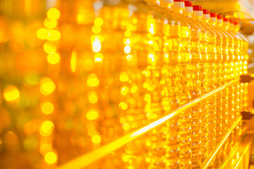 Oil in bottles. Industrial production of sunflower oil. Conveyor line for bottling and packing....
