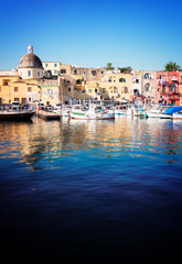 Marina Grande Port with colorful old houses of Procida island, Italy, retro toned